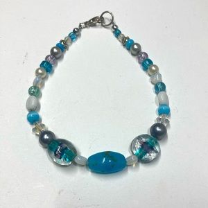 Handmade beaded bracelet in clear, white, and turquoise. Original design